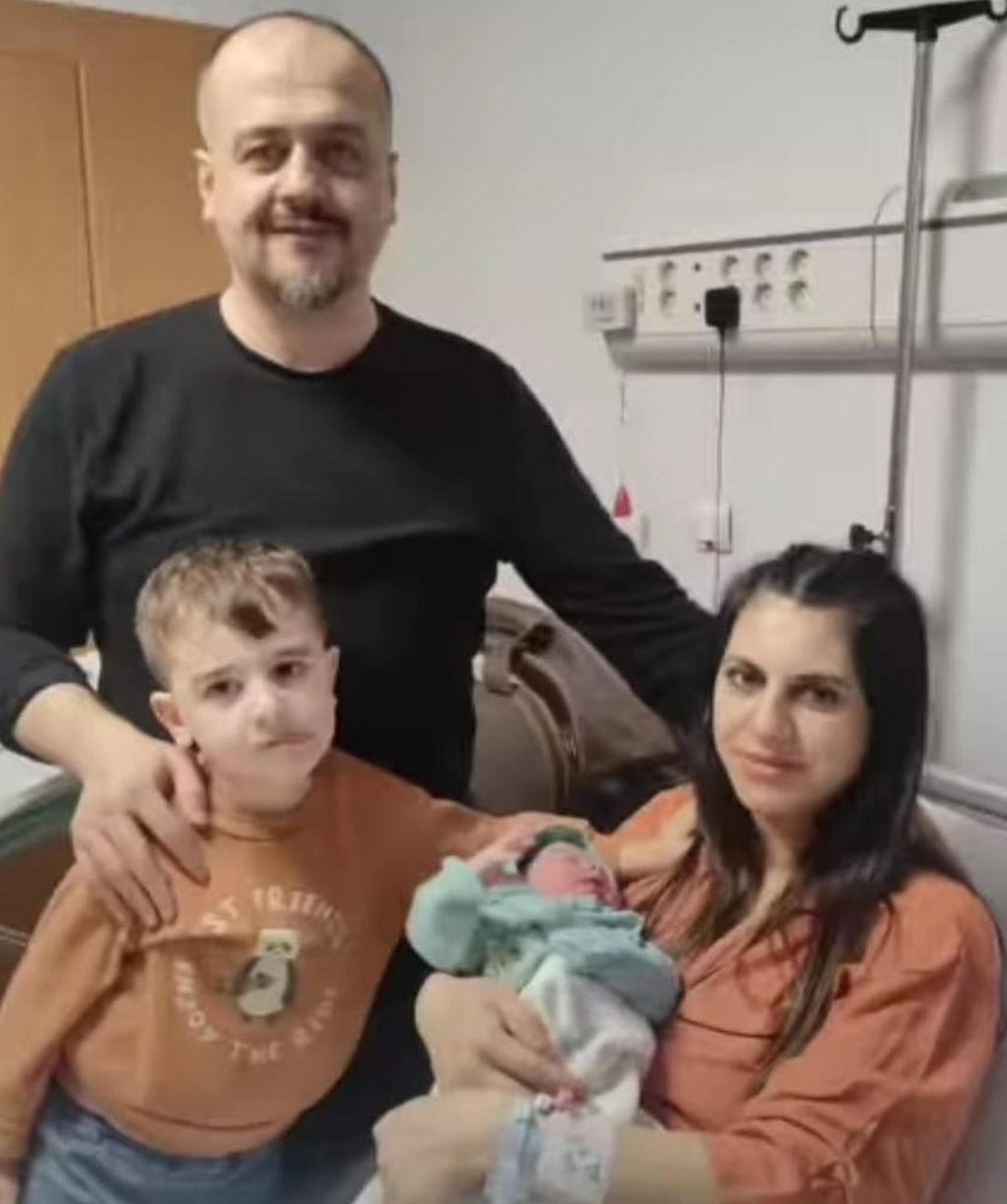 Necla with her husband Irfan and three-year-old son Yigit Kerim in hospital